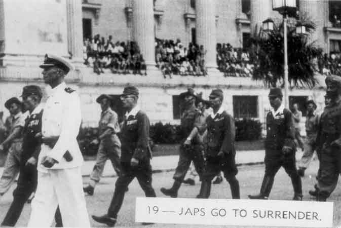 019 - Japs go to surrender
Japanese General Itagaki and other senior Japanese officers being escorted to the Singapore Municipal Buildings for the signing of the surrender terms. 
Keywords: Surrender