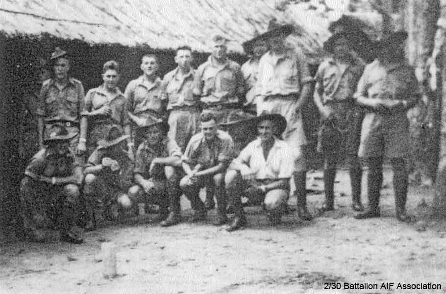 Carrier Platoon
Carrier Platoon in camp in Malaya.

Left to right:

Back row:
1) Unknown (behind Jack BLACK's right shoulder)
2) NX4411 - BLACK, John George Jeffrey (Jack), Pte. - HQ Company, Carrier Platoon 
3) NX36654 - WIGHTMAN, Arthur Egerton (Ege/Whitey), Pte. - HQ Company, Carrier Platoon
4) NX37421 - PLOWES, Stuart Hilton, Pte. - HQ Company, Carrier Platoon 
5) NX47651 - STAADER, Arthur Edward, Pte. - HQ Company, Carrier Platoon
6) NX4512 - CUMBERLAND, William Arthur, Pte. - HQ Company, Carrier Platoon 
7) NX20449 - MUDFORD, Clifton Hartley (Clif), Pte. - HQ Company, Carrier Platoon (behind John HASKIN's right shoulder)*
8) NX66000 - HASKINS, John (Massa), Sgt. - HQ Company, Carrier Platoon 
9) NX27235 - CROSS, Arthur Henry William, Cpl. - HQ Company, Carrier Platoon*
10) NX36444 - McNICKLE, Alan Robert, Cpl. - HQ Company, Carrier Platoon 

Front row:
1) NX2111 - COOMBES, Frank James, Pte. - HQ Company, Carrier Platoon
2) NX4643 - McCORMICK, Harold Robert (Mick), Cpl. - HQ Company, Carrier Platoon
3) NX36679 - BODY, Raymond John (Ray), Pte. - HQ Company, Carrier Platoon
4) NX20446 - WALLACE, Scott James (Scotty), Pte. - HQ Company, Carrier Platoon
5) Unknown (at rear between Scotty WALLACE and Cec PLEWES)
6) NX30290 - PLEWS, Cecil (Cec), Sgt. - HQ Company, Carrier Platoon

* identified by Ray BODY, all others identified by Jack BLACK

