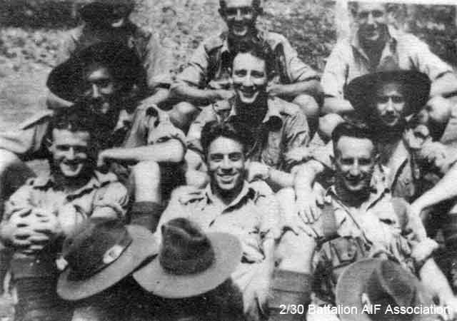 B Company, 12 Platoon
Taken while Battalion was stationed at Batu Pahat in late 1941.

Left to right:

Back row:
1) NX72066 - HICKS, Vernon Owen (Tiny), Pte. - B Company, 12 Platoon
2) NX72660 - HILL, George, Pte. - B Company, 12 Platoon
3) NX32129 - HODGES, Alfred Edward (Fred or Snowy), Pte. - B Company, 12 Platoon

Middle row:
1) NX26331 - HOLLAND, Bruce Hedley (Dutchy), Pte. - B Company, 12 Platoon
2) NX31064 - AMBROSE, Richard Robert James (Jimmy or Bluey), Cpl. - B Company, 12 Platoon
3) NX37519 - WEIR, William E. (Sailor), Pte. - B Company, 12 Platoon

Front row:
1) NX26330 (NX5078) - CHARLTON, Ronald Alan (Zipper or Ron), Pte. - B Company, 12 Platoon
2) NX29655 - GILL, Edward George Laurence (Blondie or Ted), Pte. - B Company, 12 Platoon
3) NX26332 - SYLVESTER, Walter Hackshall (Tiger), Pte. - B Company, 12 Platoon
