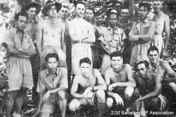 B Company, 10 Platoon
Training in Malaya with members of Johore Defence Force.

Left to right:

Back row (standing at rear):
1) NX30214 - STREATFEILD, Raymond John (Ray), L/Cpl. - B Company, Coy. HQ Platoon
2) NX27336 - MEADOWS, Arthur Samuel, Pte. - B Company, 10 Platoon 
3) Member of Johore Defence Force
4) NX55044 - DOUGLAS, William James (Billy), Pte. - B Company, Coy. HQ
5) NX37456 - McNAMARA, William Patrick (Bill), Pte. - B Company, 10 Platoon
6) NX32244 - PURVIS, Frank, Cpl. - B Company, 10 Platoon

Middle row (standing):
1) Member of Johore Defence Force
2) NX27464 - COLLETT, Frederick George (Fred), Pte. - B Company, 10 Platoon
3) NX28821 - RUSSELL, Eric Stuart, Sgt. - D Company, 16 Platoon
4) Member of Johore Defence Force
5) Member of Johore Defence Force

Front row (kneeling):
1) Member of Johore Defence Force
2) NX26367 - SMITH, Allan Claude, Pte. - B Company, 10 Platoon
3) NX2715 - McWILLIAMS, Alexander George (Alex), Cpl. - B Company, Protective Platoon
4) Member of Johore Defence Force
5) NX26539 - GOODWIN, John Arthur (Jack), Pte. - HQ Company, Mortar Platoon
Keywords: Makan265