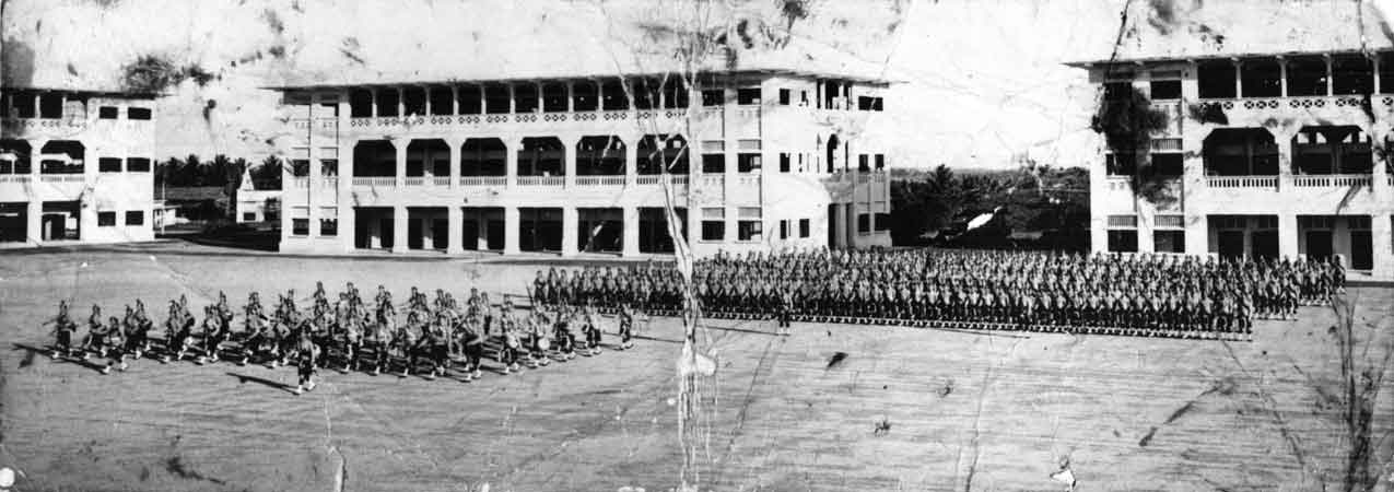 Selarang Barracks
Troops on parade.

The building in the centre of this photograph was occupied by the men of the 2/30th, during their time as Prisoners of War.

(Information provided by Bill DESMET in December, 2006)

