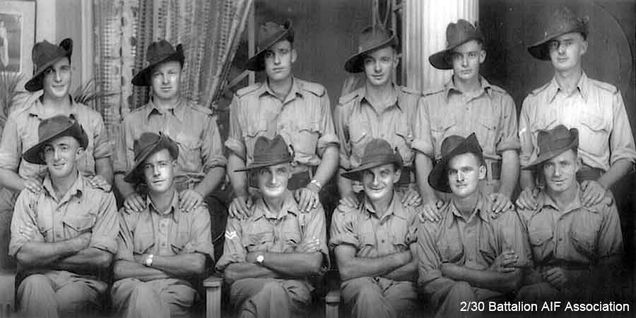D Company, 18 Platoon, 7 Section
This photo appeared in Makan 246, and Makan 336 with the following caption:

Taken at Batu Pahat.

Back row, L. to R.: Ray Godbolt, Bill Newton, Bill Galbraith, Jack Carey, Dal Oldknow, Clive Glover.
Front Row: Harold Godbolt, Lloyd Stuart, Ron Langley, Bob Beattie, Harry Griffis, Bill Dainton.

Left to right:
Back row:
1) NX47319 - GODBOLT, Raymond Cecil (Ray), Pte. - D Company, 18 Platoon
2) NX47342 - NEWTON, William Henry Andrew (Bill), Pte. - D Company, 18 Platoon
3) NX51831 - GALBRAITH, William Martin, Pte. - D Company, 18 Platoon
4) NX51660 - CAREY, John Peter (Jack), Pte. - D Company, 18 Platoon
5) NX47185 - OLDKNOW, Norman Dallas (Dal), Pte. - D Company, 18 Platoon
6) NX58219 - GLOVER, Leslie Clive, L/Cpl. - D Company, 18 Platoon

Front Row:
1) NX47320 - GODBOLT, Harold, Pte. - D Company, 18 Platoon 
2) NX60594 - STUART, Lloyd Thomas, Pte. - D Company, 18 Platoon 
3) NX35581 - LANGLEY, Roland (Ron), Cpl. - D Company, 18 Platoon
4) NX47652 - BEATTIE, Robert George (Bob), Pte. - D Company, 18 Platoon
5) NX47322 - GRIFFIS, Henry Alfred (Poly), Pte. - D Company, 18 Platoon 
6) NX25857 - DAINTON, William Henry, Pte. - BHQ Company, Cook D Company

Caption provided by R.A. HUDSON reads:

Left to right:

Back row:
1) NX58219 - GLOVER, Leslie Clive, L/Cpl. - D Company, 18 Platoon
2) NX47342 - NEWTON, William Henry Andrew (Bill), Pte. - D Company, 18 Platoon
3) NX51660 - CAREY, John Peter (Jack), Pte. - D Company, 18 Platoon 
4) NX60594 - STUART, Lloyd Thomas, Pte. - D Company, 18 Platoon
5) NX47322 - GRIFFIS, Henry Alfred (Poly), Pte. - D Company, 18 Platoon
6) NX47652 - BEATTIE, Robert George (Bob), Pte. - D Company, 18 Platoon

Front row:
1) NX51831 - GALBRAITH, William Martin, Pte. - D Company, 18 Platoon
2) NX47320 - GODBOLT, Harold, Pte. - D Company, 18 Platoon
3) NX47185 - OLDKNOW, Norman Dallas (Dal), Pte. - D Company, 18 Platoon
4) NX25857 - DAINTON, William Henry, Pte. - BHQ Company, Cook D Company
5) NX47319 - GODBOLT, Raymond Cecil (Ray), Pte. - D Company, 18 Platoon
6) NX35581 - LANGLEY, Roland (Ron), Cpl. - D Company, 18 Platoon
Keywords: Makan246 Makan336