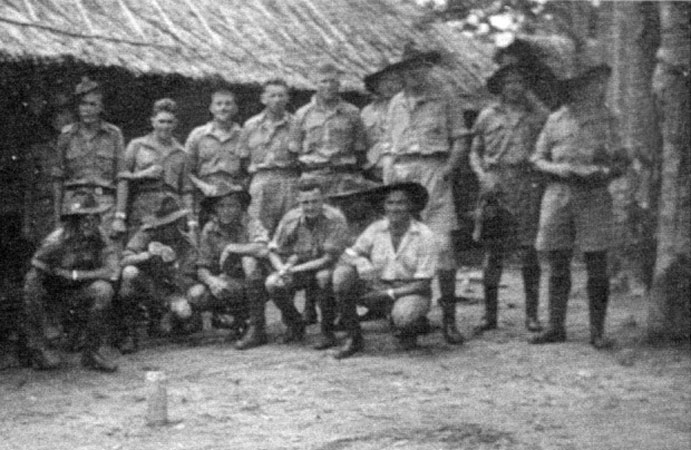Carrier Platoon
Carrier Platoon in camp in Malaya.

Left to right:

Back row:
1) Unknown (behind Jack BLACK's right shoulder)
2) NX4411 - BLACK, John George Jeffrey (Jack), Pte. - HQ Company, Carrier Platoon
3) NX36654 - WIGHTMAN, Arthur Egerton (Ege/Whitey), Pte. - HQ Company, Carrier Platoon
4) NX37421 - PLOWES, Stuart Hilton, Pte. - HQ Company, Carrier Platoon
5) NX47651 - STAADER, Arthur Edward, Pte. - HQ Company, Carrier Platoon
6) NX4512 - CUMBERLAND, William Arthur, Pte. - HQ Company, Carrier Platoon
7) NX20449 - MUDFORD, Clifton Hartley (Clif), Pte. - HQ Company, Carrier Platoon (behind John HASKIN's right shoulder)*
8) NX66000 - HASKINS, John (Massa), Sgt. - HQ Company, Carrier Platoon
9) NX27235 - CROSS, Arthur Henry William, Cpl. - HQ Company, Carrier Platoon*
10) NX36444 - McNICKLE, Alan Robert, Cpl. - HQ Company, Carrier Platoon

Front row:
1) NX2111 - COOMBES, Frank James, Pte. - HQ Company, Carrier Platoon
2) NX4643 - McCORMICK, Harold Robert (Mick), Cpl. - HQ Company, Carrier Platoon
3) NX36679 - BODY, Raymond John (Ray), Pte. - HQ Company, Carrier Platoon
4) NX20446 - WALLACE, Scott James (Scotty), Pte. - HQ Company, Carrier Platoon
5) Unknown (at rear between Scotty WALLACE and Cec PLEWES)
6) NX30290 - PLEWS, Cecil (Cec), Sgt. - HQ Company, Carrier Platoon

* identified by Ray BODY, all others identified by Jack BLACK 
Keywords: 081224a