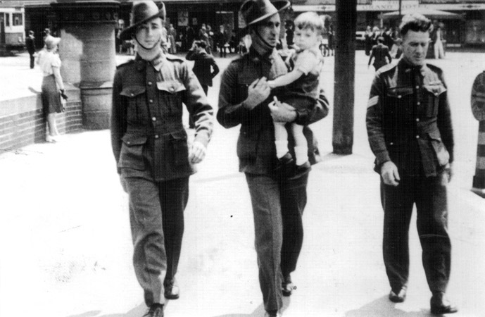 On leave in Sydney
Left to right:
1) NX32703 - MOYNIHAN, William James (Bill ), Sgt. - D Company, 17 Platoon
2) ? carrying Bill MOYNIHAN's son, Jim.
3) ?

Photo taken in Sydney.
Keywords: 090811a