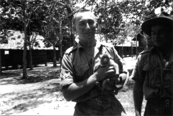 Bill Moynihan with Monkey
Bill wrote:

"This little monkey belongs to an Englishman who was not camped far away from us when we first arrived in Malaya. Notice the likeness between it and myself whil my hair is off."

Person on the right is possibly the monkey's owner.

Left to right:
1) NX32703 - MOYNIHAN, William James (Bill ), Sgt. - D Company, 17 Platoon 
2) ?
Keywords: 090811a