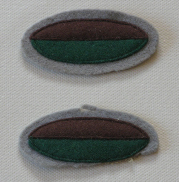 2/20 Battalion Colour Patch
An original design 2/20 Battalion colour patch from 1940. This design was superseded in October 1940 by a diamond shape, horizontally divided into white over green, on a light grey oval background.
Keywords: 100214c NX32306