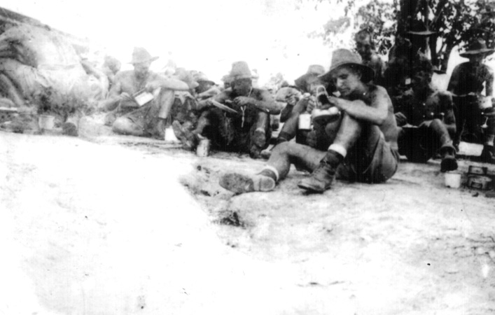 Eating Rice, Selarang
This photo was taken by NX37745 - ASPINALL, George Henry (Changi), Pte. - HQ Company, Transport Platoon and appeared in the book, Changi Photographer.

The caption read:

"Another water-damaged negative. Arthur Isaac is on the extreme right of this shot and Tommy Lee is spooning up some rice in the centre of the group. Tommy was lost on the Thai-Burma Railway."

Identified in the photo are:
1) NX51730 - ISAAC, Arthur William John (Ike), A/U/L/Sgt. - D Company, 17 Platoon
2) NX46265 - LEE, Thomas (Tom), Pte. - D Company, 17 Platoon 
Keywords: 20101103i