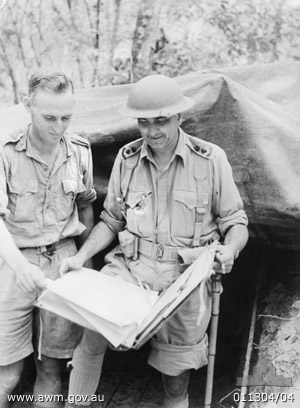 Command Post, Gemas
Australian War Memorial caption reads:
GEMAS, MALAYA. 1942. LIEUTENANT COLONEL FREDERICK G. "BLACK JACK" GALLEGHAN, COMMANDING OFFICER 2/30TH BATTALION (RIGHT), EXAMINING A MAP WITH SERGEANT HECKENDORF (LEFT), INTELLIGENCE SERGEANT, OUTSIDE THE BATTALION COMMAND POST.

Left to right:
1) NX36791 - HECKENDORF, Erwin Ernest (Curly), Sgt. - BHQ, Intelligence.
2) NX70416 - GALLEGHAN (Sir), Frederick Gallagher (Black Jack), Brig. - BHQ. CO. 2/30 Bn. D.S.O., O.B.E., I.S.O., E.D., K.B.
Keywords: 100105c