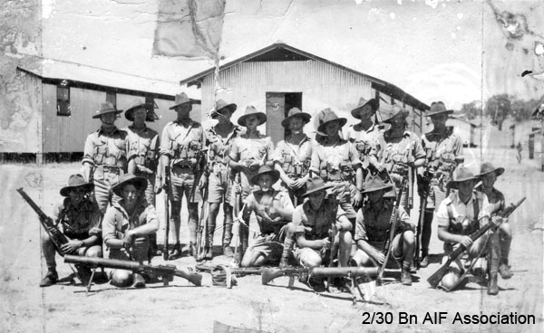 Mortar Platoon in training
This photo may have been taken at Bathurst, as the Battalion was accomodated in tin sheds at Bathurst Army Camp, Kelso.

Front row, kneeling, left to right:
1. Unknown
2. Unknown
3. Unknown
4. Unknown
5. Unknown
6. Unknown
7. Unknown

Back row, standing, left to right:
1. Unknown
2. Unknown
3. Unknown
4. Unknown
5. Unknown
6. Unknown
7. NX32306 - MACIVER, Donald Gunn (Bluey), Cpl. - HQ Company, Mortar Platoon (possible)
8. Unknown
9. Unknown
10. Unknown
Keywords: bathurstcamp