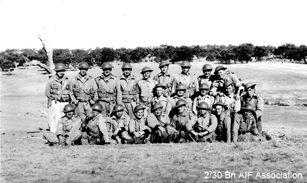 Mortar Platoon at Bathurst, 1941
The Mortar Platoon in training at Bathurst, shortly before embarkation for Malaya.

Front row, left to right:
1) NX27259 - BLADWELL, Frederick Joseph, Sgt. - HQ Company, Mortar Platoon
2) NX54474 - STEVENS, Francis Rupert Brotherson (Snowy), Pte. - HQ Company, Mortar Platoon
3) NX31365 - McHUGH, Michael John (Mick), Pte. - HQ Company, Mortar Platoon
4) NX54467 - STONE, Eric William, Cpl. - HQ Company, Mortar Platoon
5) NX30386 - SPRING, Eric, Pte. - HQ Company, Mortar Platoon
6) NX32900 - SMITH, Reginald (Butch), Pte. - HQ Company, Mortar Platoon
7) NX32306 - MACIVER, Donald Gunn (Bluey), Cpl. - HQ Company, Mortar Platoon
8) NX24089 - HARRIS, John Evan (Scotty/Cock), Cpl. - HQ Company, Mortar Platoon
9) NX58187 - BARNS, Victor, L/Sgt. - HQ Company, Mortar Platoon

Middle row, left to right:
1) NX50446 - WALSHE, James Prior (Splinter), Pte. - HQ Company, Mortar Platoon
2) NX65999 - BLOW, Ernest John Stewart (Stew), Sgt. - HQ Company, Mortar Platoon
3) NX45847 - EVERINGHAM, Albert Clemen (Clem), L/Sgt. - HQ Company, Mortar Platoon
4) NX57292 - OWEN, Campbell Dunlop (Blue), Pte. - HQ Company, Mortar Platoon
5) NX47592 - WALLWORK, Martin Russell, Pte. - HQ Company, Mortar Platoon

Back row, left to right:
1) NX58157 - GREENWOOD, Frederick John (Jack), Pte. - HQ Company, Mortar Platoon
2) NX46561 - COOK, Max, Pte. - HQ Company, Mortar Platoon
3) NX32019 - WILMOTT, Alexander John, Pte.
(enlisted as NX32019 - John Allan WILLMOTH on 13/6/1940; taken on strength with 2/30 Bn. at Tamworth on 22/11/1940; discharged in absentia on 3/9/1941; re-enlisted as NX78032 - Pte. Alexander John WILMOTT on 11/12/1941 and rejoined 2/30 Bn. on 26/1/1942)
4) NX54739 - TAPP, David Slader, Pte. - HQ Company, Mortar Platoon
5) NX70447 - KRECKLER, John Francis (Bib), Lt. - HQ Company, 2 I/c Mortar Platoon
6) NX46503 - TATE, David William, A/U/Sgt. - HQ Company, Mortar Platoon
7) NX41145 - LOVE, Sydney George, Pte. - HQ Company, Mortar Platoon
8) NX24909 - DU ROSS, Stanley Claude Melbourne (Frenchy), Sgt. - HQ Company, Mortar Platoon
9) NX15405 - McALISTER, Albert James (Abby), A/U/WO2 - HQ Company, A/CSM
Keywords: bathurstcamp