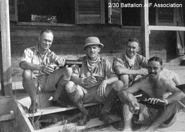 Officers' Mess, Batu Pahat
Relaxing on the steps of the Officers' Mess.

Left to right:
1) NX12530 - COOPER, James Herbert (Jim), Lt. - HQ Coy. Carrier 2 I/c. MiD OBE. O/C 12pl. B. & OC Sig. Pl
2) NX12542 - TOMPSON, Richard Clive, Capt. - HQ Coy. O/C Carrier Pl.
3) NX33560 - MEILLON, John Alwyn, Lt. - A Coy.  Liaison Officer 27 Bde., WiA Causeway
4) NX70437 - KEARNEY, Peter Desmond (Black Prince), Capt. - B Coy. 2 I/c
