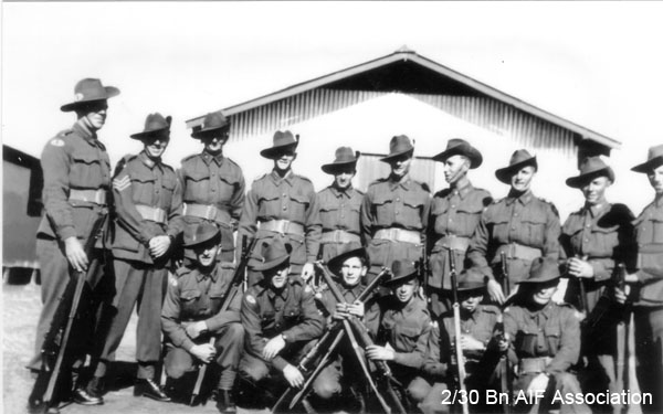 Signals Platoon, Bathurst, 1941
Left to right:
Back row, standing:
1) NX47129 - COOTE, George Bentley, Pte. - HQ Coy. Sig. Pl. Doi Sonkurai 1 (Cholera)
2) NX55561 - HALL, Leslie Gordon (Les), Sgt. - HQ Company, Signals Platoon, MiD
3) NX45174 - LONIE, John Graham (Jack), Pte. - HQ Coy. Sig. Pl. 
4) NX47678 - PALMER, Cecil Noel (Cec), Pte. - HQ Coy. Sig. Pl. 
5) NX47487 - McLEAN, Kevin Noel, Pte. - HQ Coy. Sig. Pl.
6) NX36248 - MURPHY, Peter Jeffries, Pte. - HQ Coy. Sig. Pl. Doi Sonkurai 3 (Ulcers, Malaria)
7) NX25715 - MASSEY, Thomas Fox (Hank), L/Cpl. - HQ Coy. Sig. Pl. 
8) NX46994 - McKINNON, Douglas Albert (Doug), Pte. - HQ Coy. Sig. Pl. WiA Gemas, Repatriated 10/2/1942, to New Guinea Rifles
9) NX47492 - NEWMAN, Ronald (Snooks), Pte. - HQ Coy. Sig. Pl. 
10) Unknown

Front row, kneeling:
1) NX30495 - MOORE, Frank Montague (Baldy), Cpl. - HQ Company, Signals Platoon
2) NX30302 - McNAB, James Alistair, L/Cpl. - HQ Coy. Sig. Pl. Ex "A" Force; sent from Thailand to Japan after Railway completed; Awa Maru; Doi Sendryu Japan
3) NX67449 - JOHNSON, Robert William (Togo), Cpl. - HQ Coy. Sig. Pl. Doi Sonkurai 1 (Acute Bacillary Endocarditis)
4) NX65486 - QUINTAL, Laurie Patterson, Pte. - HQ Coy. Sig. Pl. Doi Tanbaya (Beri Beri, Dysentery)
5) NX55172 - PHILLIPS, Clarence James (Tankie), Pte. - HQ Coy. Sig. Pl. Doi Khorkan (Post Amputation, Dysentery, Beri Beri)
6) NX46196 - DAVISON, Robert Shaw (Scotty), Pte. - HQ Coy. Sig. Pl. Doi Kanburi (Cardiac Beri Beri, Pneumonia)

Keywords: bathurstcamp