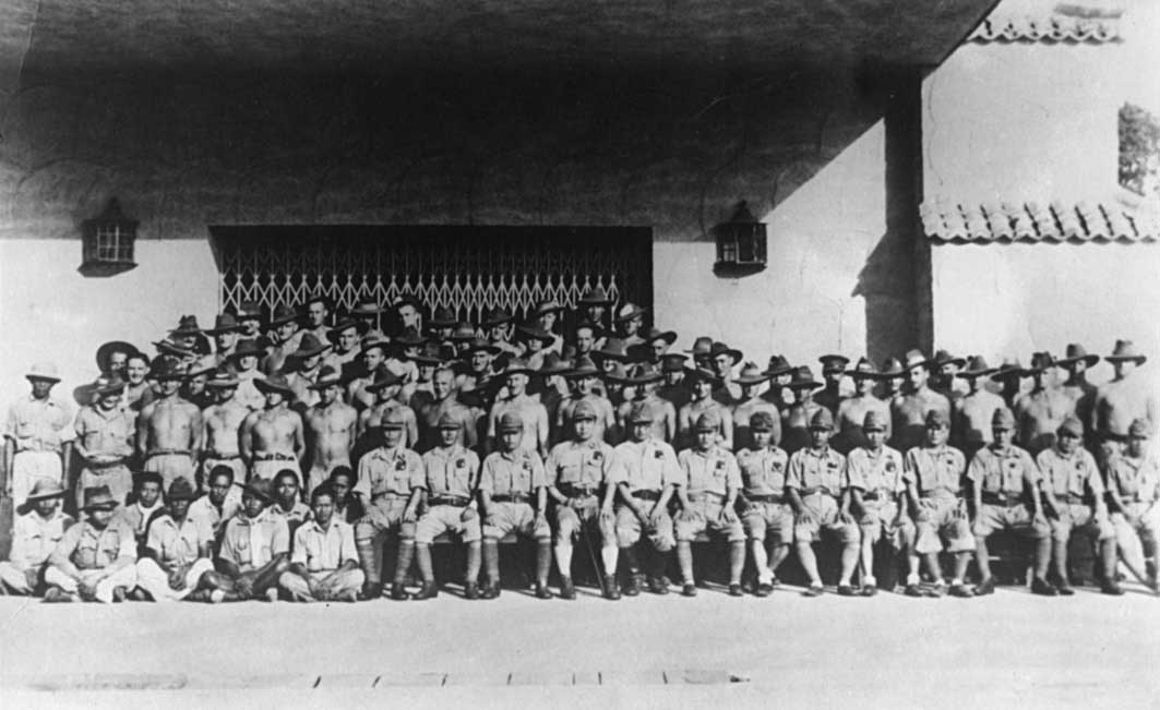 St. Andrew's College Working Party
Various members of the 2/30th were assigned to a working party at St. Andrew's College, Serangoon Road, Singapore in early 1942.

1) QX10481 - ANDERSON, William  (Bill), Pte. - D Company, 18 Platoon. Ex 2/26 Bn 16/1/1942, WiA Mandai Rd.
2) NX30430 - BELL, Wallace Speare (Wally Mark 11), Pte. - A Coy. 8 Pl. Broken leg while at Blakang Mati, returned to Changi for treatment
3) NX56869 - BLANSHARD, Douglas Copeland (Doug), Sgt. - A Company, 8 Platoon. 
4) NX2751 - BOYTON, William John (Bill), Pte. - B Company, 10 Platoon. 
5) NX36401 - BROWN, George Hilton, Lt. - A Company, O/C 8 Platoon. ToS 26/12/1941, Ex GBD
6) NX47483 - BROWN, Harry Robert, Pte. - A Company, 8 Platoon. 
7) NX29821 - BURGESS, Clarence John (Clarrie), L/CPlatoon. - A Company, 7 Platoon. 
8) NX26414 - CAHILL, Robert Edward (Bob), Pte. - HQ Company, A/A Platoon. Doi Sonkurai 3 (Beri Beri, Dysentery)
9) QX17105 - CAHILL, Walter Herbert, Pte. - A Company, 8 Platoon. to 2/26 Bn 31/12/1942
10) NX71966 - CARROLL, John Leslie (Jack), Pte. - A Company, 9 Platoon. Doi Sonkurai 1 (Cholera)
11) NX33290 - CHAPMAN, Keith Milford (Chappie), Pte. - A Company, 8 Platoon. 
12) NX60171 - CORCORAN, Francis Leslie, Pte. - C Company. Ex 2/19 Bn 2/2/1942; to 2/19 Bn 21/12/1942, Doi Sandakan
13) NX52475 - CROWLEY, James Lancelot, Pte. - C Company. 6 Rnf; ToS 2/2/1942; to 2/19 Bn 21/12/1942 (standing behind 4th Jap on right of photo)
14) NX49041 - DALY, William Herbert, Pte. - A Company. 
15) NX2748 - DESPOGES, John Samuel (Darkie), Pte. - HQ Company, Pioneer Platoon. 
16) NX77751 - DICKENSON, John, Pte. - C Company, 15 Platoon. 
17) NX56759 - DOUGLAS, Noel James, Pte. - A Company, 9 Platoon. to 2/26 Bn 3/1/1943
18) NX47564 - DOWLING, Kevin John, Pte. - A Company, 9 Platoon. 
19) NX10901 - ERWIN, Clarence Robert (Charlie), Pte. - A Company, 8 Platoon. 
 (Dysentery, Beri Beri)
20) NX10862 - FING, William, Pte. - A Company, 7 Platoon. 
21) NX73973 - FLEW, Mark Waterford, Pte. - C Company, 15 Platoon. 
22) NX37294 - FORWARD, Kenneth (Frank Walter Leslie) (Ken), Pte. - C Company, 13 Platoon. 
23) NX47481 - GAY, Kenneth John, Pte. - HQ Company, Sig. Platoon. 
24) NX71311 - GAYFORD, Ernest Reginald, Pte. - A Company, 9 Platoon. 
25) NX30821 - HANLON, Lindsay Roy (Red), Pte. - B Company, 11 Platoon. WiA Gemencheh
26) NX72520 - HANSEN, Jens, Pte. - B Company 
27) NX47343 - HARDY, Charles Victor (Andy), Pte. - C Company, 13 Platoon. 
28) NX58970 - HENNESSY (De St. Hilair), Sydney Rudolph (Sid), Pte. - B Company, 11 Platoon. WiA Sempang Rengam
29) NX27191 - HUDSON, William Michael Charles (Bill), Pte. - BHQ, Intell. Doi Train Ipoh (Dysentery)
30) NX2538 - JOHNSTON, Ronald Athol, CPlatoon. - C Company, 14 Platoon. 
31) NX42283 - KINGSTON, George, Pte. - A Company, 8 Platoon. 
32) NX25731 - KANE, Russell John, Pte. - HQ Company, Carrier Platoon.
33) NX27205 - KINSELA, George Michael, Pte. - HQ Company, Carrier Platoon. 87 LAD AAOC attached 6/12/1941
34) NX30942 - LARKIN, Stanley Raymond, Pte. - B Company, 11 Platoon. WiA Ayer Hitam
35) NX10888 - LAWTY, Edwin (Ted), Pte. - C Company. 
36) NX20447 - MASON, Joseph (Joe), Pte. - HQ Company, Carrier Platoon. 
37) NX20450 - MASON, Peter , CPlatoon. - HQ Company, Carrier Platoon. 
38) NX37655 - McBURNEY, Ronald James (Ron), Pte. - A Company, 7 Platoon. 
39) NX26339 - McCALLUM, Edwin Roy (Tanglefoot), Pte. - B Company, 12 Platoon. Doi Sonkurai 3 (Cholera)
40) NX4643 - McCORMICK, Harold Robert (Mick), CPlatoon. - HQ Company, Carrier Platoon. Doi Sonkurai 1 (Cerebral Malaria)
41) NX47385 - NYBERG, William Lawrence, Pte. - D Company, 18 Platoon. WiA Mandai Rd, Doi Tanbaya 39) 42) 42) NX31544 - PLUIS, Cyril, Pte. - HQ Company, Transport Platoon. WiA Gemas
43) NX65486 - QUINTAL, Laurie Patterson, Pte. - HQ Company, Sig. Platoon. Doi Tanbaya (Beri Beri, Dysentery)
44) NX36535 - RANDLE, Edward R. (Ted/ Snowy), Pte. - A Company. 
45) VX55924 - ROSE, Morton John (Mort), Pte. - A Company, 7 Platoon. to 2/29 Bn 22/3/1942, Doi Taimonta
46) NX67520 - SENIOR, Leslie William (Billy or Debbil Debbil), Pte. - HQ Company, Pioneer Platoon. 
47) NX55717 - SMYTH, Patrick Thomas, Pte. - B Company, 10 Platoon. Doi Nieke (Amputation Leg, Post op Debility)
48) NX72633 - STEPHENS, Cuthbert Edward James (Bert), Pte. - HQ Company, Transport Platoon. 
49) NX54474 - STEVENS, Francis Rupert Brotherson (Snowy), Pte. - HQ Company, Mortar Platoon. 
50) NX52874 - TODD, Edgar Frank (Bluey), Pte. - A Company, 7 Platoon. 
51) NX57645 - TYSON, James Sydney (Sid), CPlatoon. - B Company, Company, HQ Platoon. Ex 2/19 Bn 2/2/1942, Doi Sonkurai 1 (Cholera)
52) NX2536 - UPCROFT, Ernest Bruce (Bruce), Pte. - D Company, 18 Platoon.
53) NX34206 - WALLACE, Edward Charles (Wally), Pte. - C Company, Platoon. Ex 2/19 Bn 4/2/1942; to 2/19 Bn 21/12/1942
54) NX45020 - WATKINS, Norman Alfred, Pte. - A Company, 9 Platoon. 
55) QX21455 - WATSON, Robert Arthur (Bob), Pte. - B Company, 12 Platoon. Doi Sonkurai 3 (Dysentery)
56) NX25458 - WATT, Edward Louvain (Ted), CPlatoon. - A Company, 9A Platoon. Took Discharge in Singapore
57) NX49282 - WAUGH, Norman Sidney (Norm), Pte. - B Company, 10 Platoon. Doi Kanburi (Exhaustion following Cardiac Beri Beri)
58) NX36696 - WEBB, Francis John (Spider), Pte. - HQ Company, Carrier Platoon. 
59) NX52631 - WEST, Donald Simm (Don), Pte. - B Company, Platoon. 
60) NX36654 - WIGHTMAN, Arthur Egerton (Ege/Whitey), Pte. - HQ Company, Carrier Platoon. 
61) NX78041 - WILLIAMS, George Frederick (Snow), Pte. - A Company, 8 Platoon. Doi Kanu 2 (Malaria, Cardiac Beri Beri)
Keywords: StAndrewsCollege