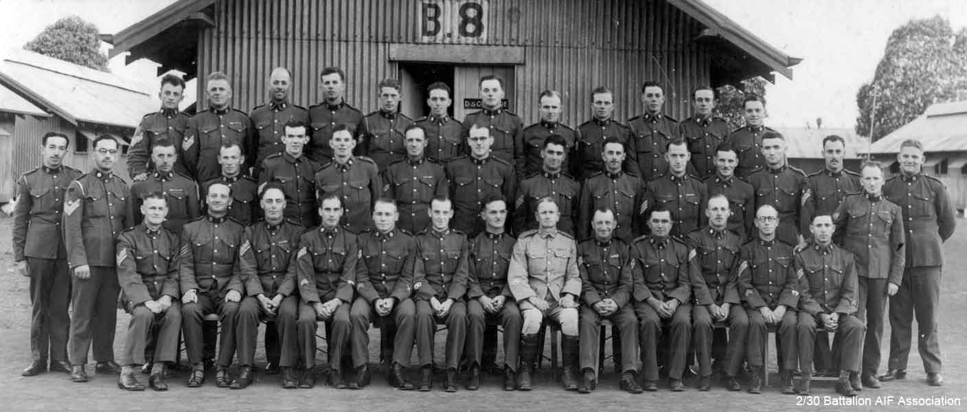 1st Battalion
1st Battalion (City of Sydney Regiment) - Serjeants

Liverpool Camp - 1st December, 1939.

Left to right:

Back row:
1) NX109336 (N4421) - FROST, William George Lloyd, A/CSM (later Sergeant - 555 Light Anti-Aircraft Regiment)
2) NX102725 (N36787) - ROBINSON, Eric Douglas, C/Sjt. (later Major - 1 Battalion DIR)
3) NX70486 (N35795) - BOOTH, Edward Holroyd, L/Sjt. (later Captain - 2/30 Battalion AIF)
4) NX12515 (N74340) - HAINS, Ivan, Sjt. (later Lieutenant - HQ 27 Australian Infantry Brigade)
5) NX9446 - FRESHWATER, James Thomas, L/Sjt. (later Corporal - 9 Division Signals)
6) NX29683 - WAGNER, Charles Arthur, Sjt. (later Lieutenant - 2/18 Battalion AIF)
7) NX12151 - FORREST, James Spraggon, Sjt. (later Lieutenant - 16 Australian Infantry Brigade, Reinforcements)
8) NX5294 - ROBERTS, Henry Arthur, Sjt. (later Sergeant - 2/4 Battalion, AIF)
9) NX70706 - GARVEY, Eric Boyd, Sjt. (later Captain - 2/1 Australian Machine Gun Battalion)
10) NX34746 (N73239) - TIDSWELL, Neville John, L/Sjt. (later Lieutenant - 2/2 Anti Tank Regiment)
11) NX127372 (N35798) - AHERN, F.J., Sjt.
12) NX70448 - FARR, Albert Irwin, Sjt. (later Lieutenant - 2/30 Battalion, AIF)

Middle row:
1) ? - COUGHLIN, C.H., L/Sjt.
2) NX175527 (22348) - PETERSON, Humphrey William Grey, C. Sjt. (later Warrant Officer Class 1 - 4 Australian Army Ordnance Depot)
3) N74392 - MCNEILL, David Gordon, L/Sjt. (later Warrant Officer Class 1 - 23 Australian Infantry Training Battalion)
4) NX1021 - ALEXANDER, Brian, L/Sjt. (later Lance Sergeant - 2 Australian Per Staging Camp)
5) 36553 - MALLYON, Cyril Alan, L/Sjt. (later Sergeant - 1 ST TAF, RAAF)
6) QX21565 - WADE, William Wallace, Sjt. (later Lieutenant - 7 Machine Gun Battalion)
7) N35910 - FORSYTH, Archibold Arthur, A/CSM (later Warrant Officer Class 1 - NSW L of C Area, GDD)
8) ? - CHAMBERLIN, C.D., Sjt.
9) NX9843 - SPRINGER, Paul, A/CSM ( later Warrant Officer Class 2 - 2/3 Battalion, AIF)
10) NX35137 - THORBURN, Arthur Roy, Sjt. (later Lieutenant - 2/30 Battalion, AIF)
11) ? - SPARKES, E.A., S/Sjt.
12) NX50889 (N109991) - FRASER, Colin Hugh, L/Sjt. (later Warrant Officer Class 2 - Australian New Guinea Administrative Unit)
13) NX126751 (N109979) - CROWTHER, William John Joseph, S/Sjt. (later Sergeant BBCAU)
14) NX12228 - MACLARN, Leslie Cecil, C/Sjt. (Major - 2/17 Battalion, AIF)
15) N35814 - GRIFFITH, Francis Joseph, L/Sjt.
16) NX9299 - BOYER, Kenneth Mowbray, C/Sjt. (later Captain - 2/3 Battalion, AIF)

Front row:
1) ? - WILLIAMS, G.M.G. Sjt.
2) N35805 - ABBOTT, John Bilney, L/Sjt. (later Captain - 1st Battalion)
3) N23876 (N72262) - HORDER, Victor Stafford, Sjt. (later Warrant Officer Class 2 - 29 Australian Infantry Training Battalion)
4) NX139666 (N36791) - THURLOW, Ronald Boyer, Sjt. (later Lieutenant - 6 Australian Machine Gun Battalion)
5) ? - MAPLEDORAN, R., Sjt.
6) NX143305 (2422) - HOOK, Charles Leslie, WOII (later Lieutenant - 1/45 Australian Infantry Battalion)
7) ? - TAYLOR, W., WOII
8) ? - ROSS, R.J., WOII
9) N71595 - CAIRNDUFF, Roy Edward, Sjt. (later Private - Base HQ, Eastern Command)
10) NX66092 - NOTLEY-SMITH, Neville Nathan, Sjt. (later Sapper - 2/6 Field Engineers)
11) NX102512 (N35802) - EINFIELD, John Isidore, L/Sjt. (later Captain - HQ 2 Australian Corps)
12) ? - DWYER, A.E.J, C/Sjt.
13) NX342 - CATTERNS, Basil Wilfred Thomas, Sjt. (later Major - 2/1 Battalion, AIF)

Absent:
1) ? - FORBES, G.J.C., Sjt.
2) ? - PUGH, Drum Major
3) NX101879 (N36808) - HARDMAN, Owen Bendict, Sjt. (later Captain - 1/45 Australian Infantry Battalion)
4) ? - WATSON, G.W.R., Sjt.
5) NX101016 (240024) - CLEARY, Harry Edward, Sjt. (later Major - RAE (FD))
6) NX76254 - ARCHY, Frank Downs, Sjt. (later Major - 7 PW Regt. Comp.)
7) NX131347 (N171089) - BARKER, Jack Robert, Sjt. (later Sapper - 7 Australian Mechanical Equipment Company)
8) NX101317 (N35793, N77820) - MANSON, James Williamson, Sjt. (later Captain - A Branch Army Headquarters)
9) NX9302 - ISHERWOOD, Cortis Sydney, L/Sjt. (later Lieutenant - PSL)
10) NX34702 - FEWTRELL, Douglas Cecil, L/Sjt. (later Lieutenant - 15 Australian Ordnance Ammunition Section)
Keywords: 070415