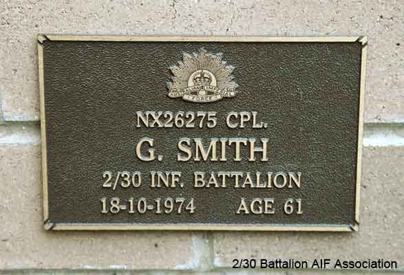 NX26275 - SMITH, George, Cpl. - A Company, 7 Platoon
View of the bronze plaque erected in the NSW Garden of Remembrance on Wall 23, Row D. The garden is adjacent to Sydney War Cemetery at the Rookwood Necropolis, and is maintained by The Office of Australian War Graves.

The plaques are provided by The Office of Australian War Graves to commemorate eligible veterans who have died post war and whose deaths are accepted as being caused by war service. This form of commemoration is used when there is a private memorial elesewhere, or for some reason, the Office is unable to provide an official memorial at the relevant Cemetery or Crematorium.
