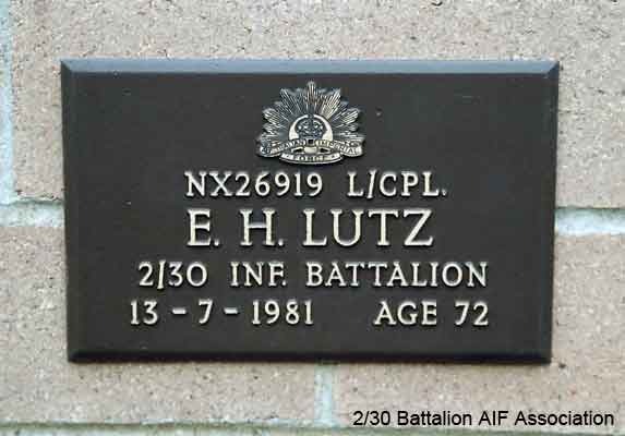 NX26919 - LUTZ, Edward Herman (Ted), L/Cpl. - B Company, Coy. HQ
View of the bronze plaque erected in the NSW Garden of Remembrance on Wall 5, Row D. The garden is adjacent to Sydney War Cemetery at the Rookwood Necropolis, and is maintained by The Office of Australian War Graves.

The plaques are provided by The Office of Australian War Graves to commemorate eligible veterans who have died post war and whose deaths are accepted as being caused by war service. This form of commemoration is used when there is a private memorial elesewhere, or for some reason, the Office is unable to provide an official memorial at the relevant Cemetery or Crematorium.
