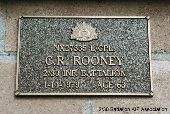 NX27339 - ROONEY, Clifford Roy (Micky or Cliff), A/Cpl. - HQ Company, Pioneer Platoon
View of the bronze plaque erected in the NSW Garden of Remembrance on Wall 27, Row J. The garden is adjacent to Sydney War Cemetery at the Rookwood Necropolis, and is maintained by The Office of Australian War Graves.

The plaques are provided by The Office of Australian War Graves to commemorate eligible veterans who have died post war and whose deaths are accepted as being caused by war service. This form of commemoration is used when there is a private memorial elesewhere, or for some reason, the Office is unable to provide an official memorial at the relevant Cemetery or Crematorium.
