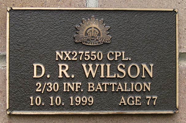NX27550 - WILSON, David Royce (Doc), A/Cpl. - A Company, 9 Platoon
View of the bronze plaque erected in the NSW Garden of Remembrance on Wall 37, Row J. The garden is adjacent to Sydney War Cemetery at the Rookwood Necropolis, and is maintained by The Office of Australian War Graves.

The plaques are provided by The Office of Australian War Graves to commemorate eligible veterans who have died post war and whose deaths are accepted as being caused by war service. This form of commemoration is used when there is a private memorial elesewhere, or for some reason, the Office is unable to provide an official memorial at the relevant Cemetery or Crematorium. 
Keywords: 100125b