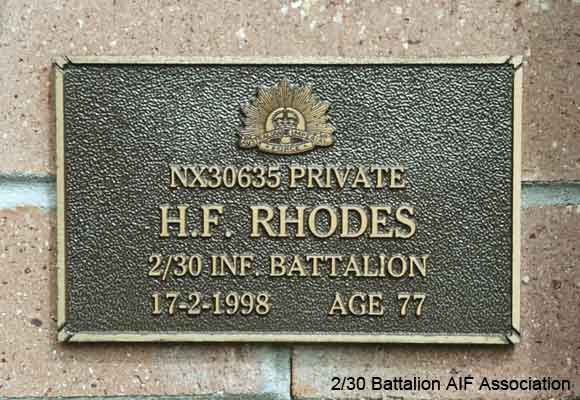 NX30635 - RHODES, Harry Francis, Pte. - B Company, 10 Platoon
View of the bronze plaque erected in the NSW Garden of Remembrance on Wall 30, Row O. The garden is adjacent to Sydney War Cemetery at the Rookwood Necropolis, and is maintained by The Office of Australian War Graves.

The plaques are provided by The Office of Australian War Graves to commemorate eligible veterans who have died post war and whose deaths are accepted as being caused by war service. This form of commemoration is used when there is a private memorial elesewhere, or for some reason, the Office is unable to provide an official memorial at the relevant Cemetery or Crematorium.
