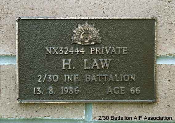 NX32444 - LAW, Henry (Harry), Pte. - A Company, 7 Platoon
View of the bronze plaque erected in the NSW Garden of Remembrance on Wall 37, Row B. The garden is adjacent to Sydney War Cemetery at the Rookwood Necropolis, and is maintained by The Office of Australian War Graves.

The plaques are provided by The Office of Australian War Graves to commemorate eligible veterans who have died post war and whose deaths are accepted as being caused by war service. This form of commemoration is used when there is a private memorial elesewhere, or for some reason, the Office is unable to provide an official memorial at the relevant Cemetery or Crematorium.
