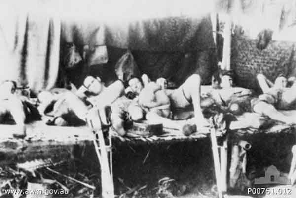 Amputation ward
Burma-Thailand Railway. c. 1943. "Amputation ward" in Bamboo Hut Hospital at a prisoner of war (POW) camp along the Burma-Thailand railway. The POWs have mostly had legs amputated because of uncontrollable tropical ulcers. (Donor A. Mackinnon)
