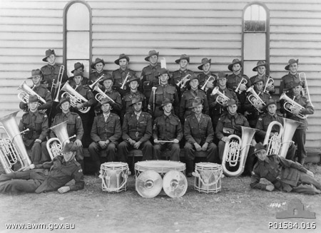 2/30 Battalion Band
Back Row (L to R):
1) NX68238 - DESMET, Stanley Joseph (Bill), Pte. - Trombone - "F" Force
2) NX68235 - COPLEY, Francis Peter, Pte. - Solo Cornet - "F" Force
3) NX68236 - LUGTON, Stanley James (Stan), Cpl. - Solo Cornet - "F" Force
4) NX36270 - ELPHICK, James Jack (Jack), Pte. - Solo Cornet - "F" Force
5) NX67631 - WATTERSON, Rowland Hubert (Roly), Sgt. - G Trombone - Died Kanburi No. 1 10/12/1943
6) NX36324 - BROUFF, Charles William (Charlie), Pte. - Cornet - "F" Force
7) NX66840 - WILKINSON, Dudley Norman, Pte. Cornet or Tenor Horn - "A" Force
8) NX68237 - HODGE, William Peter (Bill), Pte. - Cornet - "F" Force
9) NX68186 - HODGES, Alfred William James, Pte. - Cornet - Died Kami Sonkurai 16/10/1943 - "F" Force
10) ? - McLEOD, J., Pte. - Trombone

Middle row (L to R):
1) NX46929 - MIDDLETON, William (Bill), Cpl. - Eupho - Leader of Concert Party Orchestra, Changi
2) NX36142 - PARSONS, Lindsay Heyhoe, L/Cpl. - Eupho - Did not sail from Bathurst
3) NX57915 - VOLLHEIM, Eric Charles Norman, Pte. - Tenor Horn - "B" Force
4) NX53156 - BROWNBILL, Ronald Will Leonard (Bill), Pte. - Horn - Died at Tamarkan, 12/1/1944 - "A" Force
5) NX36443 - RINGWOOD, Stanley, Sgt.  - Drum Major
6) NX36719 - MONTGOMERY, James William (Jim), Pte. - Side Drums - "F" Force
7) NX36267 - WHITTERON, Edward Sprowell (Ed), Pte. - Horn - Died Kuie 10/6/1943 - "F" Force
8) NX41078 - CROSSMAN, Alan Byron, Pte. - Baritone - Died at Kami Sonkurai, 16/10/1943 - "F" Force
9) NX35482 - MOUNTFORD, Laurence Gordon (Laurie), L/Cpl - Baritone - "J" Force

Front row (L to R):
1) NX69851 - RYAN, Patrick Leonard (Len), Pte. - B. B. Bass - "F" Force
2) NX36839 - EDMONDSTONE, Bertie Joseph (Bert), Pte. - B. B. Bass - Died at Shimo Sonkurai 29/8/1943 - "F" Force
3) NX34999 - RAMSAY, George Ernest, Major (Second in Command)
4) NX70416 - GALLEGHAN, Frederick (Black Jack) Gallagher, Lieutenant Colonel (Commanding Officer)
5) NX66171 - PALMER, Sidney John, Sgt - Bandmaster, Conductor & Solo Cornet - "B" Force
6) NX34738 - LAMACRAFT, Alfred Maudslay (Alf), Captain (Adjutant)
7) NX68232 - TEMPLEMAN, John James (Ben), Pte. - E Bass - "A" Force
8) NX68185 - BOWDEN, Thomas Arthur (Tom), Pte. - E Bass - "F" Force

Reclining (L to R):
1) NX36271 - GOUGH, William George (Bill), Pte. - Bass Drum - "A" Force
2) NX36098 - HART, James (Shorty), Pte. - Side Drum - "F" Force

Other Band members:
1) NX46241 - BARRETT, Victor Leslie, Pte. - "F" Force
2) NX72156 - JORDAN, Sydney Alfred Arthur, Pte. - Cornet - "F" Force
3) NX72160 - JORDAN, Walter Leo George, Pte. - Trombone
4) NX47007 - ROBINSON, Howard Charles (Bill), Pte. - Cornet - "A" Force

(Sources: Black Jack, AWM ID No. P01584.016, 2/30 Bn Nominal Roll, Makan 196, 242)
Keywords: 100105c