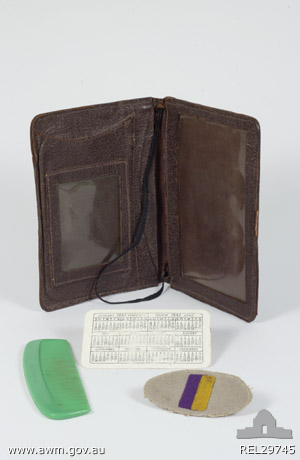 Wallet with comb, colour patch and calendar - Private C. J. Smith, 2/30 Battalion
Physical description:
Leather; Plastic; Felt; Brown leather wallet with broken stud fastening. One side of the wallet is made up of a pocket with a clear plastic window. Inside this pocket is a green plastic comb and a plastic card printed on one side with a calendar for 1941 and the reverse with 1942. The other side of the wallet is divided into four pockets. The top pocket is smaller than the others and also has a clear plastic window. A colour patch for 2/30 Battalion is stored inside. The patch is a grey oval with a vertically alinged rectangle of purple next to yellow sewn in the centre.

Summary:
Associated with NX2573 Private Charles James Smith from Lismore, NSW. Smith was born in Bangalow, NSW in 1915 and joined the AIF on 23 April 1941. He served with 2/30 Battalion in Malaya and was taken prisoner by the Japanese. He was kept as as prisoner of war in Thailand and died there on 1 November 1943.

NX2573 - SMITH, Charles James (Jim), Pte. - HQ Company, Transport Platoon. Died of illness, Sonkurai 3 (Dysentery)
Keywords: NX2573SMITH