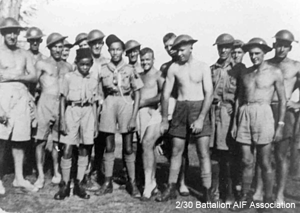 Pioneer Platoon
Two Malayan scouts with some of Pioneer Platoon

Left to right:
1) NX56747 - HIGGINS, Thomas Henry (Tom), Cpl. - HQ Coy. Pioneer Pl. Doi Sonkurai 1 (Cholera)
2) Unknown
3) NX31563 - MOSELEY, Henry John (Harry), Pte. - HQ Coy. Pioneer Pl. Doi Sonkurai 1 (Cholera)
4) Unknown
5) Unknown
6) Unknown
7) NX36242 - WESTON (Bright), Jack (Jackie), Pte. - HQ Coy. Pioneer Pl. Doi Sonkurai 1 (Heart Failure following Cholera)
8) NX67520 - SENIOR, Leslie William (Billy or Debbil Debbil), Pte. - HQ Coy. Pioneer Pl. 
9) NX56479 - BROWN, Henry John (Scobie), Pte. - HQ Coy. Pioneer Pl. 
10) NX2844 - THORLEY, Norman Edward, Pte. - HQ Coy. Pioneer Pl. 
11) NX33906 - HOOD, Robert (Bob), Sgt. - HQ Coy. Pioneer Pl. Doi Tanbaya (Ulcer, Toxaema)
12) Unknown
13) NX29682 - DIVEN, James McWhirter (Jimmy), Pte. - HQ Coy. Pioneer Pl. 
14) NX26862 - McCLELLAND, Alexander (Max), Pte. - HQ Coy. Pioneer Pl. 
