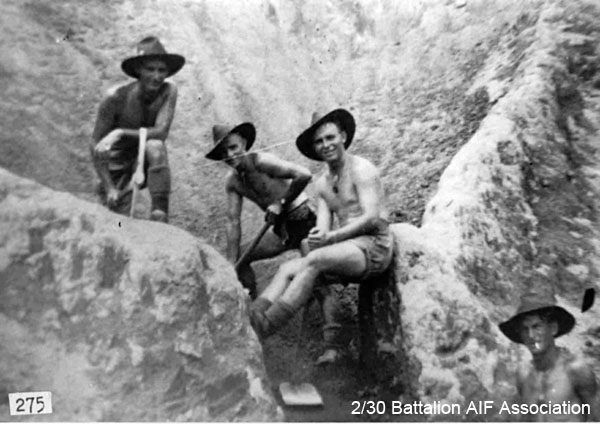 Quarry at Batu Pahat
Four of the Signallers having a spell in the quarry at Batu Pahat, Malaya, 1941

Left to right:
1) NX67449 - JOHNSON, Robert William (Togo), Cpl. - HQ Company, Signals Platoon
2) NX47487 - McLEAN, Kevin Noel, Pte. - HQ Coy. Sig. Pl. (leaning on shovel)
3) NX47492 - NEWMAN, Ronald (Snooks), Pte. - HQ Coy. Sig. Pl. (with chunkel)
4) NX46914 - BROWN, Alan Keith, Pte. - HQ Coy. Sig. Pl. Doi Train Koncoyta (Cardiac Beri Beri, Dysentery)
(or possibly NX30302 - McNAB, James Alistair (Jimmy), L/Cpl. - HQ Company, Signals Platoon)

A copy of this photo appeared in a Weekend Magazine supplement, in the The Northern Daily Leader on 18/11/2000. The caption read as follows:

"Young and fit: Soldiers preparing a weapons point in Tamworth. Three of the four men were named: second from left Kevin Newman, Ron Newman and bottom right Alan Brown."
