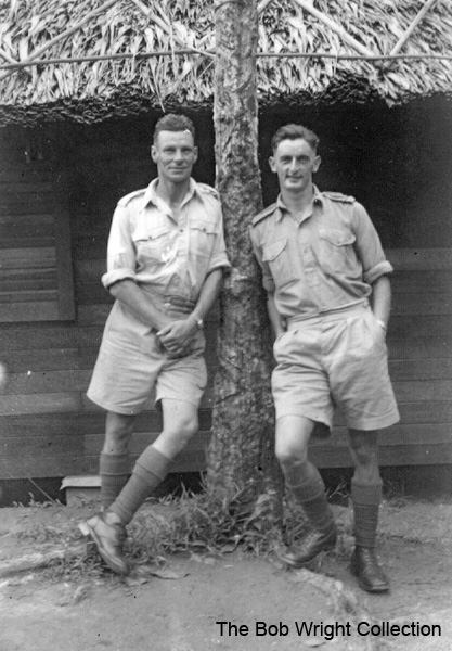 Signals Hut at Batu Pahat
"This is outside our hut. The other fellow is Jack Lonie, one of our Sigs., and a Scots Pommie. The tree is a rubber tree."

Left to right:
1) NX36166 - WRIGHT, Robert, Cpl. - HQ Coy. Sig. Pl. 
2) NX45174 - LONIE, John Graham (Jack), Pte. - HQ Coy. Sig. Pl.

1. The photographs are to be known as The Bob Wright Collection.
2. Reproduction of the Collection or any part of it is prohibited without written permission.
3. Permission is granted to the 2/30th Batallion Association to reproduce the Collection as it deems appropriate.
4. Permission is granted to the Australian War Memorial Museum to reproduce the Collection as it deems appropriate.
5. All other permission is specifically withheld.
6. Written application for permission to reproduce the Collection, or part of it, may be made to:
Mr I. Wright
95 Hewitt Avenue
Wahroonga 2076 New South Wales

