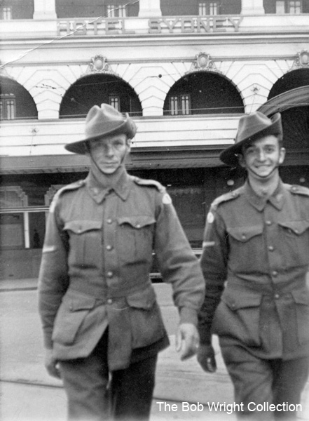 Outside the Hotel Sydney
Left to right:
1) NX36166 - WRIGHT, Robert, Cpl. - HQ Coy. Sig. Pl. 
2) Unknown

1. The photographs are to be known as The Bob Wright Collection.
2. Reproduction of the Collection or any part of it is prohibited without written permission.
3. Permission is granted to the 2/30th Batallion Association to reproduce the Collection as it deems appropriate.
4. Permission is granted to the Australian War Memorial Museum to reproduce the Collection as it deems appropriate.
5. All other permission is specifically withheld.
6. Written application for permission to reproduce the Collection, or part of it, may be made to:
Mr I. Wright
95 Hewitt Avenue
Wahroonga 2076 New South Wales

