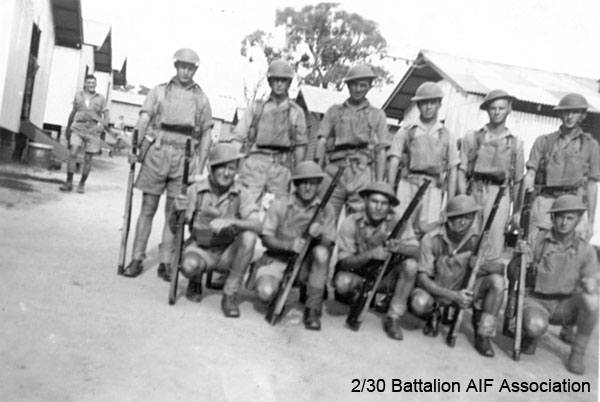 A Company, 9 Platoon, 7 Section
March 1941, at Bathurst Camp

Left to right:
In background:
1) NX30530 - HODGE, Albert Thomas (Bert), Pte. - A Company, 9 Platoon 

Back row:
1) NX60583 - NOAKES, Ernest Francis (Frank), Pte. - A Company, 9 Platoon 
2) NX25458 - WATT, Edward Louvain (Ted), Cpl. - A Company, 9A Platoon
3) NX41394 - PARSONS, John Thomas (Jack), Pte. - A Company, 9 Platoon
4) NX31018 - BRENNAN, Vincent Joseph (Vince), Pte. - A Company, 9 Platoon
5) NX31697 - McDIARMID, Anthony (Tony), Pte. - A Company, 9 Platoon
6) NX60586 - O'MALLEY, John Michael (Jack), Pte. - A Company, 9 Platoon 

Front row:
1) NX29196 - MOONEY, Roy Ernest (Dryballs), Pte. - A Company, 9 Platoon 
2) NX26154 - DANDIE, Alexander (Alex), L/Sgt. - HQ Coy. Ord. Room. 
3) NX25485 - GAGE, Frederick Clifton (Fred), Pte. - A Company, 9 Platoon (Discharged 7/7/1941)
4) NX31719 - TINDALL, Charles Henry (Charlie), Pte. - A Company, 9 Platoon
5) NX31689 - MASON, Walter Charles (Wally), L/Cpl. - A Company, 9 Platoon

